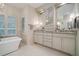Bright bathroom featuring a soaking tub, double vanity, and modern fixtures for a spa-like experience at 2080 Old Dominion Rd, Atlanta, GA 30350