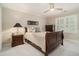 Cozy bedroom featuring a traditional wood sleigh bed, soft lighting, and neutral decor at 2080 Old Dominion Rd, Atlanta, GA 30350
