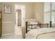 Cozy bedroom view, highlighted by a comfortable chair and view into the ensuite bathroom at 2080 Old Dominion Rd, Atlanta, GA 30350