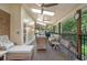 Inviting covered patio featuring wicker seating, ceiling fans, and peaceful views of the lush backyard at 2080 Old Dominion Rd, Atlanta, GA 30350