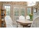 Bright dining area featuring French doors, stylish wallpaper, and wicker chairs around a round table at 2080 Old Dominion Rd, Atlanta, GA 30350