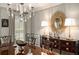 Traditional dining room with wood table, chandelier, lamps, and buffet for elegant entertaining and Gathering gatherings at 2080 Old Dominion Rd, Atlanta, GA 30350