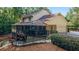Exterior side elevation view of the home with screened porch, rear entry garage and fenced yard at 2080 Old Dominion Rd, Atlanta, GA 30350