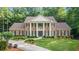 A traditional brick home with white columns, shutters, and a manicured front lawn at 2080 Old Dominion Rd, Atlanta, GA 30350