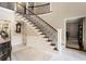 Elegant foyer featuring a staircase with dark wood steps and an open floor plan at 2080 Old Dominion Rd, Atlanta, GA 30350