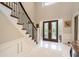 Bright foyer featuring dark wood and iron staircase, marble floors and double doors at 2080 Old Dominion Rd, Atlanta, GA 30350