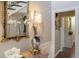 Hallway featuring a decorative table, mirror, sconces, and doorway to another room at 2080 Old Dominion Rd, Atlanta, GA 30350