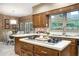 Gourmet kitchen showcasing island cooktop, wood cabinetry, and a glimpse into the adjacent dining area at 2080 Old Dominion Rd, Atlanta, GA 30350