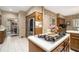 Spacious kitchen featuring island cooktop, stainless steel refrigerator, and adjacent dining area at 2080 Old Dominion Rd, Atlanta, GA 30350