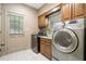 Functional laundry room with modern washer and dryer, utility sink, and window for efficient chores at 2080 Old Dominion Rd, Atlanta, GA 30350