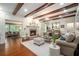 Inviting living room with wood beams, fireplace, and an open layout to another sitting area at 2080 Old Dominion Rd, Atlanta, GA 30350