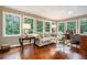 Cozy living room featuring hardwood floors, large windows offering views of the outdoors, and elegant furnishings at 2080 Old Dominion Rd, Atlanta, GA 30350