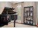 Living room featuring an elegant piano and shelving display, complemented by neutral decor and natural light at 2080 Old Dominion Rd, Atlanta, GA 30350