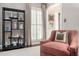 Comfortable living room featuring a reading chair, shelving, and window shutters for a classic and cozy space at 2080 Old Dominion Rd, Atlanta, GA 30350