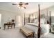 Bright main bedroom with desk, chair, four-poster bed, neutral tones, and ample natural light for a peaceful retreat at 2080 Old Dominion Rd, Atlanta, GA 30350