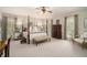 Spacious main bedroom with four-poster bed, neutral tones, and ample natural light for a peaceful retreat at 2080 Old Dominion Rd, Atlanta, GA 30350