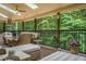 Relaxing outdoor living area boasting comfortable seating, ceiling fans, and serene backyard views at 2080 Old Dominion Rd, Atlanta, GA 30350