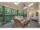 Relaxing outdoor patio with comfortable wicker furniture, ceiling fans, and a serene wooded view at 2080 Old Dominion Rd, Atlanta, GA 30350