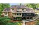 Spacious home featuring a screened porch and sunroom with a mix of brick and siding on the rear exterior at 2080 Old Dominion Rd, Atlanta, GA 30350