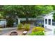 Spacious backyard with a charming patio, a cute storage building, and mature trees providing ample shade at 253 Pine Valley Dr, Powder Springs, GA 30127
