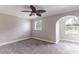 Bedroom with gray carpet, neutral paint, arched window, crown molding, and ceiling fan at 253 Pine Valley Dr, Powder Springs, GA 30127