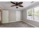 Bedroom featuring plush gray carpet, neutral paint, a ceiling fan, and a double window for light at 253 Pine Valley Dr, Powder Springs, GA 30127
