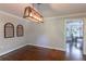Dining room with hardwood floors, modern light fixture, decorative wall art, and ample space at 253 Pine Valley Dr, Powder Springs, GA 30127
