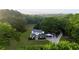 Aerial view of a beautiful home surrounded by lush greenery showcasing its private location and spacious grounds at 253 Pine Valley Dr, Powder Springs, GA 30127