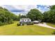 Sprawling farmhouse with beautiful yard, covered front porch, and a detached carport at 253 Pine Valley Dr, Powder Springs, GA 30127