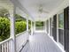 Inviting covered front porch with classic white columns and ceiling fans, perfect for enjoying the outdoors at 253 Pine Valley Dr, Powder Springs, GA 30127