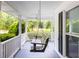 Relaxing front porch with a charming swing and ceiling fans, offering a cozy spot to unwind and enjoy the outdoors at 253 Pine Valley Dr, Powder Springs, GA 30127