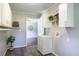 Laundry room featuring gray flooring, white cabinets and walls, and a sink with cabinet at 253 Pine Valley Dr, Powder Springs, GA 30127