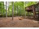 View of the home's backyard featuring a deck with stairs and an outdoor fire pit at 3573 Bramwell Nw Xing, Kennesaw, GA 30144