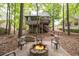 View of the home's backyard featuring an outdoor fire pit and a deck with stairs at 3573 Bramwell Nw Xing, Kennesaw, GA 30144