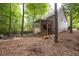 View of the home's backyard featuring a deck with stairs and an outdoor fire pit at 3573 Bramwell Nw Xing, Kennesaw, GA 30144