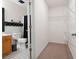 Bathroom view featuring white fixtures, checkered tile and wire storage with entry to a walk in closet at 3573 Bramwell Nw Xing, Kennesaw, GA 30144