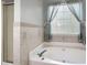 Bathroom featuring a large soaking tub and tiled detailing around the room at 3573 Bramwell Nw Xing, Kennesaw, GA 30144
