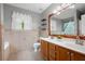 Bathroom with double vanity, tile floor, decorative mirror, garden tub, and shelves for storage at 3573 Bramwell Nw Xing, Kennesaw, GA 30144