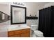Bathroom featuring a decorative mirror, white fixtures, and contrasting checkered tilework in an inviting space at 3573 Bramwell Nw Xing, Kennesaw, GA 30144