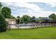 Community pool and clubhouse area with multiple lounge chairs at 3573 Bramwell Nw Xing, Kennesaw, GA 30144