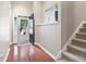 Welcoming hallway with hardwood floors, a staircase, and decorative art at 3573 Bramwell Nw Xing, Kennesaw, GA 30144