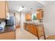 Functional kitchen with light wood cabinetry, tile flooring, and a view into the adjacent living space at 3573 Bramwell Nw Xing, Kennesaw, GA 30144