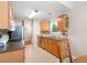 Functional kitchen with wood cabinets, modern appliances, and tiled floor at 3573 Bramwell Nw Xing, Kennesaw, GA 30144