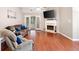 Spacious living room with hardwood floors, fireplace, and sliding glass doors leading to the backyard at 3573 Bramwell Nw Xing, Kennesaw, GA 30144