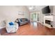 Comfortable living room showcasing hardwood floors, a fireplace, and a view of the backyard at 3573 Bramwell Nw Xing, Kennesaw, GA 30144