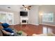 Cozy living room with fireplace, hardwood floors, and sliding door to the patio and backyard at 3573 Bramwell Nw Xing, Kennesaw, GA 30144