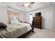 Main bedroom with carpeted floors, tray ceiling, large window, and adjacent closet and bathroom at 3573 Bramwell Nw Xing, Kennesaw, GA 30144