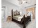 Cozy main bedroom with carpeted floors, ceiling fan, tray ceiling, and large window with curtains at 3573 Bramwell Nw Xing, Kennesaw, GA 30144