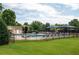 Community pool with lounge chairs and umbrella-covered tables, offering a relaxing recreational space at 3573 Bramwell Nw Xing, Kennesaw, GA 30144
