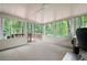Bright sun room with multiple windows, carpet floors, and a sliding door to the back deck at 3573 Bramwell Nw Xing, Kennesaw, GA 30144